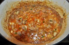 a pot filled with soup sitting on top of a stove