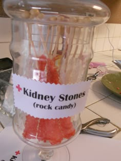 a glass jar filled with candy sticks on top of a counter