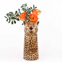 a leopard head vase with orange flowers in it on a white background, for decoration