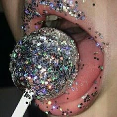 a person with glitter on their tongue holding a sparkle ball in their mouth and the words probiotic be weird above it