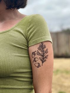 a woman with a leaf tattoo on her arm