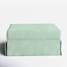 a folded sheet on top of a white surface with a light green color and pattern