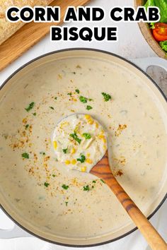 a bowl of corn and crab bisque with a wooden spoon