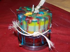 a multicolored cake sitting on top of a table