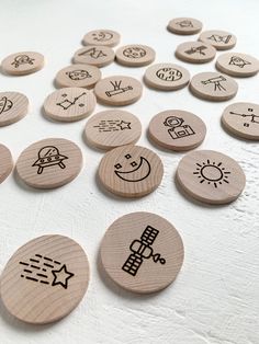 wooden buttons with space memory game symbols on them and the words space memory game written in black