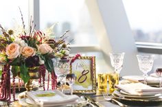 the table is set with flowers and place settings