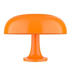 an orange table lamp on a white background