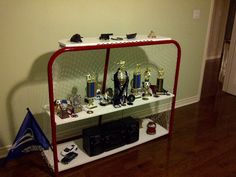 there are many trophies on the shelf in this room