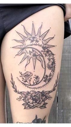 a woman's thigh with a sun and moon tattoo on it