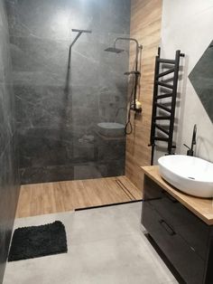 a bathroom with a sink, toilet and shower in it's own stall area