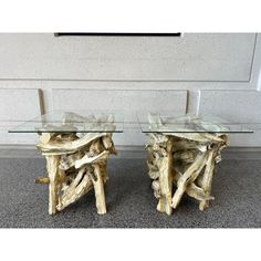 two tables made out of driftwood with glass tops