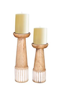 two wooden candlesticks sitting next to each other