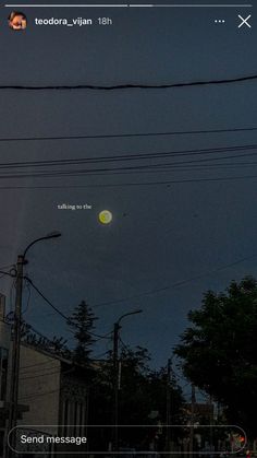 an image of the moon in the sky above some power lines and telephone poles at night