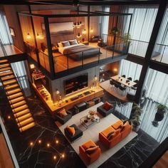 an aerial view of a living room and bedroom in a house with stairs leading up to the second floor