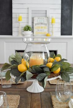 a table with candles and lemons on it