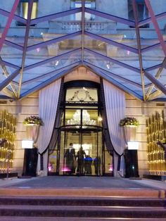 the entrance to a luxury hotel at night