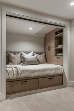 a bed sitting in the middle of a bedroom next to a walk - in closet