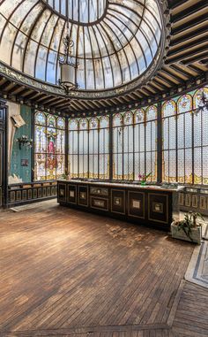 an empty room with stained glass windows and wood flooring is pictured in this image