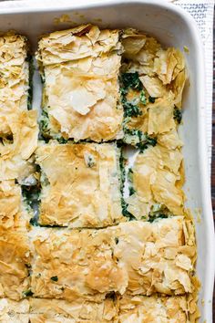 a casserole dish filled with spinach and cheese