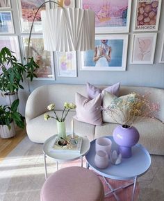 a living room filled with furniture and lots of pictures on the wall above it's coffee table