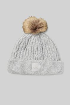 Made from soft and warming cable knit fabric and topped with a fun faux fur pom, the Cable Knit Beanie is a go-to for topping off cold weather looks. Thick, ribbed cuff holds in heat and keeps it secure. Alo Beanie, Winter Cable Knit Beanie One Size, Cozy Alpaca Beanie Hat, Soft Knit Alpaca Beanie Hat, One-size Cable Knit Beanie, Cold Weather Hats, Ballet Pink, Knit Beanie Hat, Alo Yoga