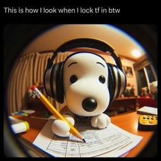 a cartoon dog with headphones sitting on top of a desk next to a pencil