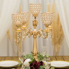 a gold candelabra with crystal candlesticks on a table set for a formal dinner