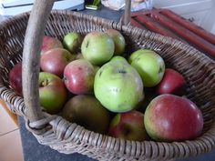 a basket filled with lots of green and red apples