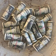 a bowl full of rolled up dollar bills