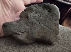 a person holding a rock in their hand