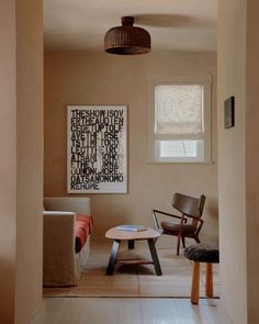 a living room filled with furniture and a painting on the wall above it's coffee table