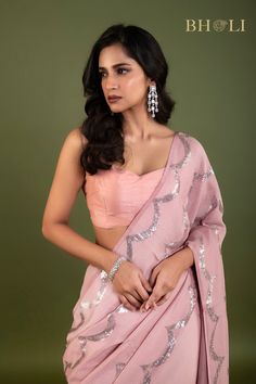 Expertly crafted with high quality Georgette fabric, this partywear saree is designed to make a statement. The elegant pink color and delicate sequin embellishments add a touch of glam to any occasion. Shine bright while feeling comfortable and confident in this must-have saree. Festive Pink Pre-draped Saree With Mirror Work, Party Pre-draped Chinon Saree With Mirror Work, Glamorous Pre-draped Saree With Cutdana For Party, Pink Sequined Pre-draped Saree For Festivals, Designer Pink Pre-draped Saree With Zari Work, Pink Tissue Silk Choli With Mirror Work, Pink Party Wear Choli With Cutdana, Diwali Party Pre-draped Tissue Silk Saree, Pink Tissue Silk Lehenga With Unstitched Blouse