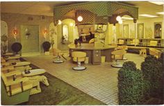 the interior of a hair salon with chairs and tables