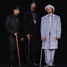 three men standing next to each other with canes