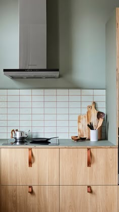 a stove top oven sitting inside of a kitchen next to wooden cabinets and counter tops