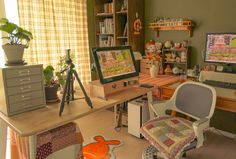 a room with desk, chair and computer monitor