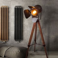 a lamp on a tripod in front of a radiator and heater