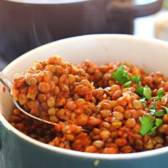 there is a spoon full of food in the bowl