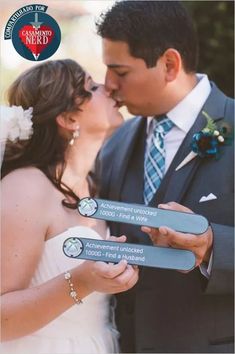 a bride and groom kissing each other in front of the camera with their name tags