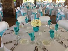 the tables are set with white and blue linens