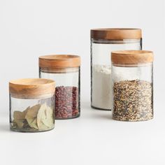 three jars filled with different types of spices