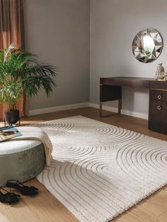 a living room with a large rug on the floor