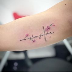 a woman's arm with a cross and flowers on it that says, new zealand generator