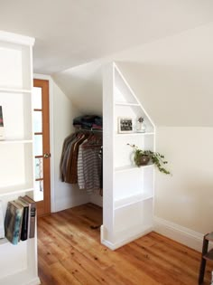 an open closet in the corner of a room