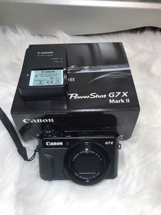 a canon camera sitting on top of a box