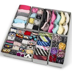 an organized drawer with ties, socks and scarves in it on a white background