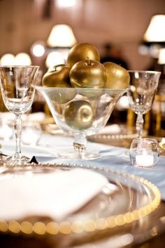 a table topped with plates and glasses filled with fruit