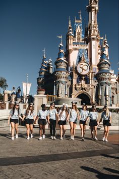 some girls are walking in front of a castle