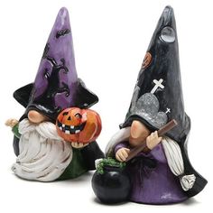 two small figurines are sitting next to each other with halloween decorations on them