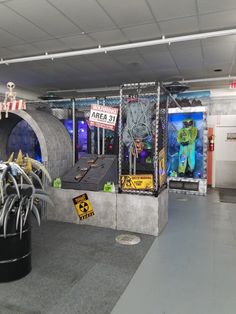 an art exhibit in the shape of a tunnel with various items on display inside it